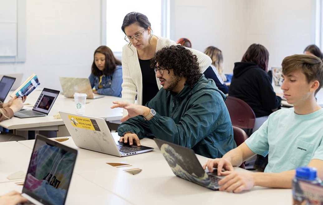 Bridgewater College students in a classroom environment wear more casual clothing, such as t-shirts and hoodies. The two gentlemen represent how students are commonly seen in more casual and comfortable clothing. 